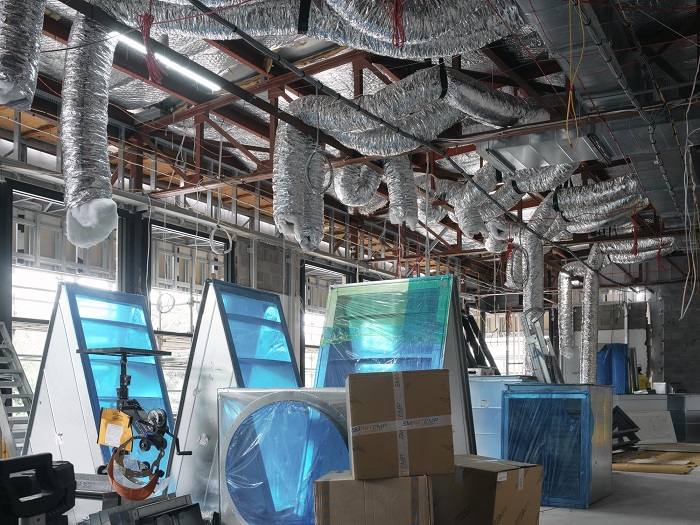 Image showing silver ducting in the roof cavity, and other materials and items waiting to be installed