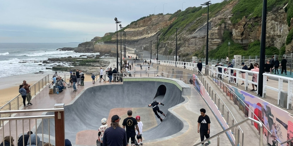 Families with kids on skateboards and scooters enjoying the new skate bowl at South Newcastle Beach and the Bathers Way upgrade.