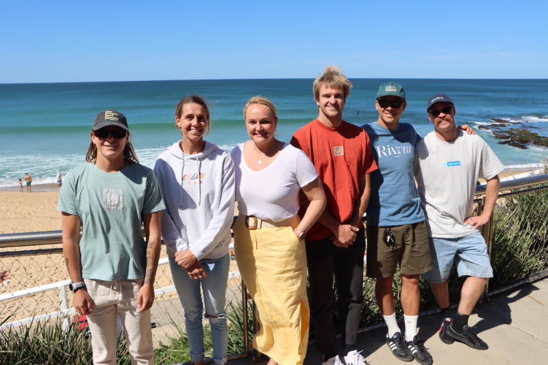 Sarah Baum, Philippa Anderson, Lord Mayor Nuatali Nelmes, Ryan Callinan, Julian Wilson and Jackson Baker at Merewether Beach.