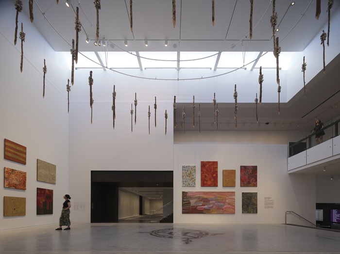 Photo looking across a set of stairs toward installed works from the collection, hung from the ceiling