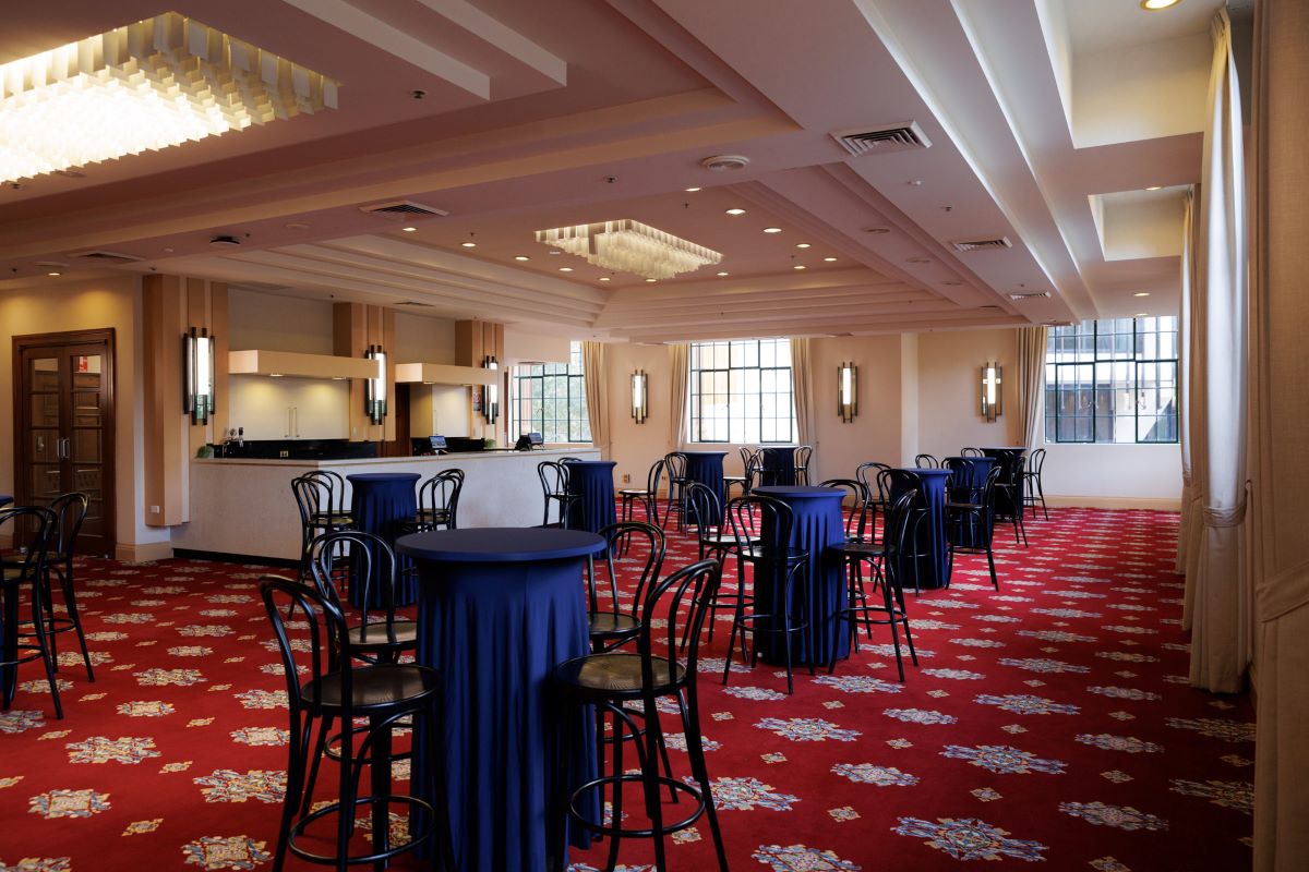 The Cummings Room at Newcastle City Hall set up with tall bar tables and black chairs, ready for a corporate event.