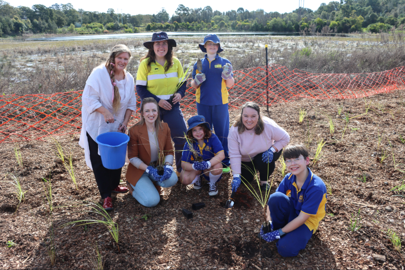 Students from Wallsend Public School join City of Newcastle's Environmental Assets Manager Karenne Jurd, Environmental Education Officer Eliza Hoyland and Ward 4 Councillors Dr Elizabeth Adamczyk and Deahnna Richardson to plant native grasses and shrubs at Wallsend